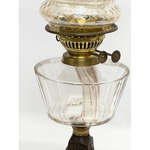 199 - A Late 19th Century Victorian double burner oil lamp, with slice cut glass bowl and cast iron base. ... 