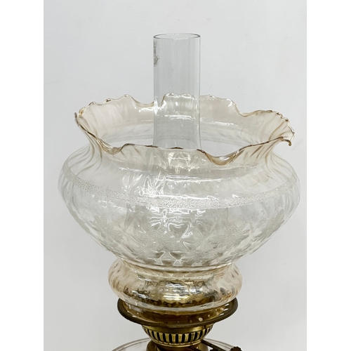 199 - A Late 19th Century Victorian double burner oil lamp, with slice cut glass bowl and cast iron base. ... 