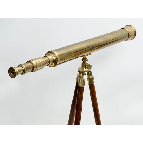 247 - A brass tabletop telescope on stand. 62x53cm