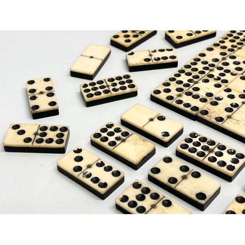 104 - A quantity of 19th Century bone and ebony dominoes.