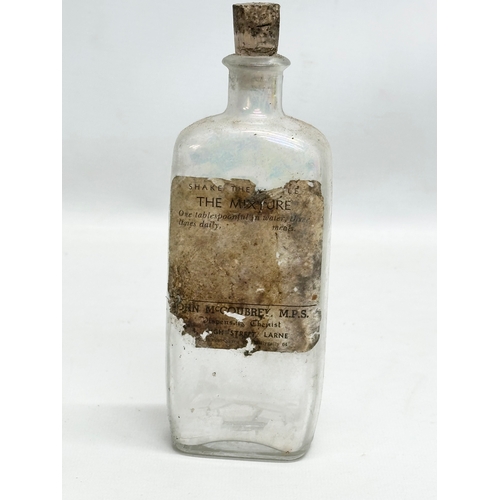 252 - A collection of Early 20th Century Northern Irish chemist bottles. 18cm, 19cm.