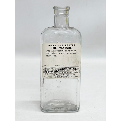 252 - A collection of Early 20th Century Northern Irish chemist bottles. 18cm, 19cm.