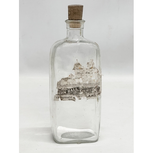 252 - A collection of Early 20th Century Northern Irish chemist bottles. 18cm, 19cm.