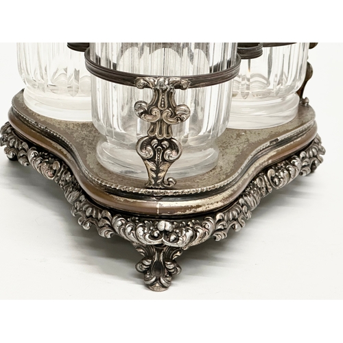 86 - Dan Holy, Parker & Co. An Early 19th Century George III silver plated decanter stand with 3 decanter... 