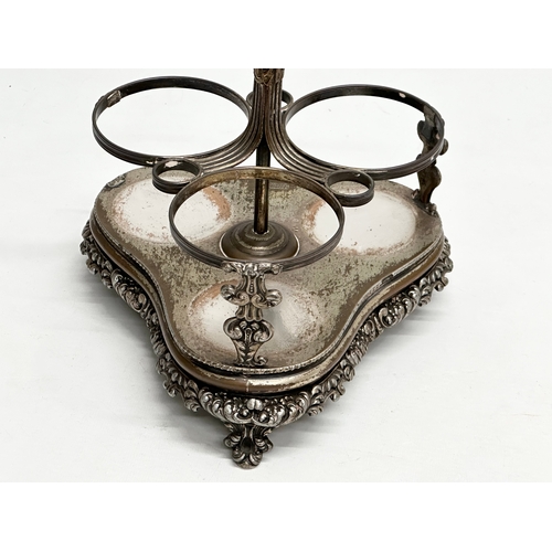 86 - Dan Holy, Parker & Co. An Early 19th Century George III silver plated decanter stand with 3 decanter... 