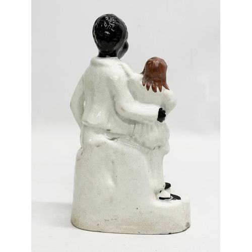 200 - A 19th Century Victorian Staffordshire Pottery ‘Uncle Tom & Eva’ 21cm.