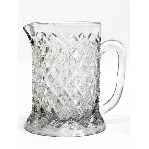 375 - 2 pieces of Late 19th Century American pressed glass. A goblet and water jug. 9x16cm. 11x11cm.