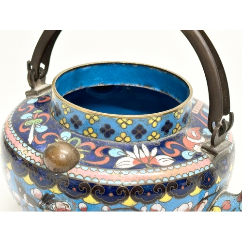 51 - A 19th Century Chinese cloisonné enamelled teapot with cover. With doubled looped brass handle. 17x1... 