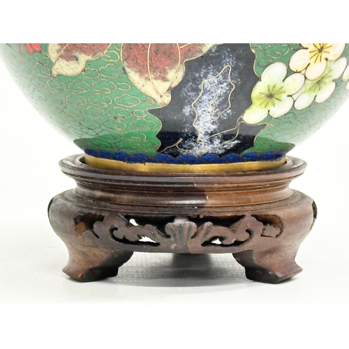 53 - An Early 20th Century Chinese cloisonné enamelled jar with lid and wooden base. 11x14cm without stan... 