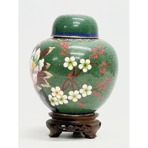 53 - An Early 20th Century Chinese cloisonné enamelled jar with lid and wooden base. 11x14cm without stan... 