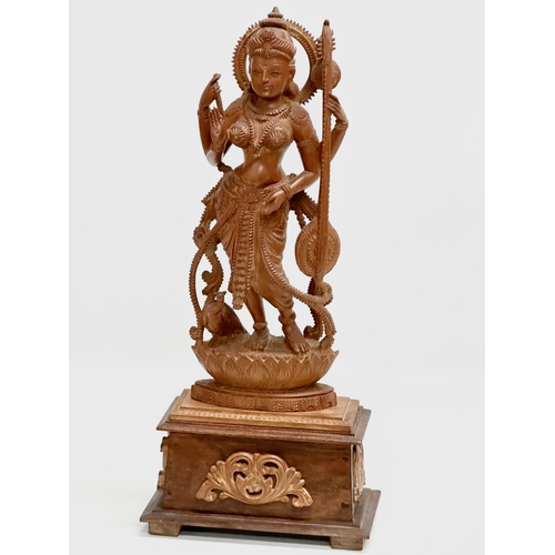 113 - A large Early 20th Century finely carved boxwood Apsara statue on padauk base. 18x11x42cm.