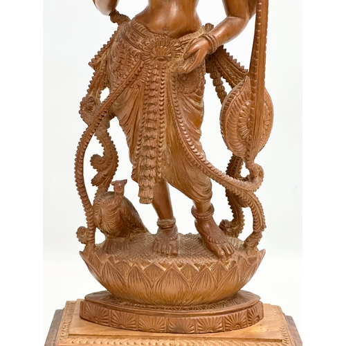 113 - A large Early 20th Century finely carved boxwood Apsara statue on padauk base. 18x11x42cm.