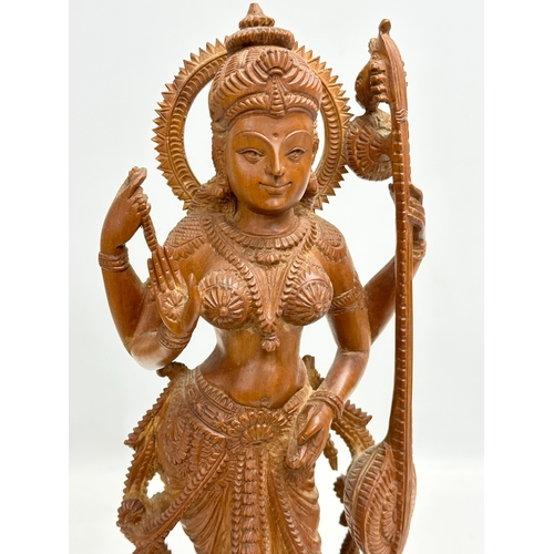 113 - A large Early 20th Century finely carved boxwood Apsara statue on padauk base. 18x11x42cm.