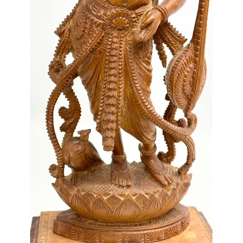 113 - A large Early 20th Century finely carved boxwood Apsara statue on padauk base. 18x11x42cm.