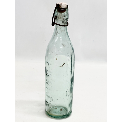 444 - 3 Early 20th Century glass bottles. 2 by Fowler of Belfast and a green gin bottle. 29cm