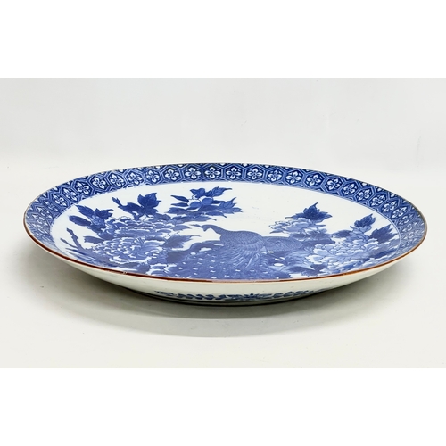 163 - A very large 19th Century Japanese Arita blue and white charger. Meiji Period (1868-1912) 45x5.5cm