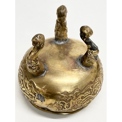 34 - A 19th Century Chinese brass tripod censer/incense burner. With engraved dragons and serpents. Raise... 