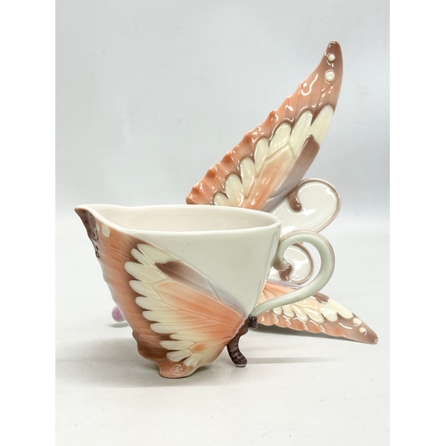 179 - A set of Franz porcelain ‘Papillon Butterfly’ cups and saucers.