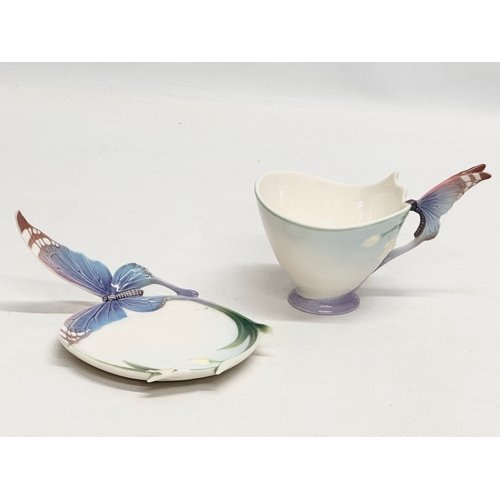 179 - A set of Franz porcelain ‘Papillon Butterfly’ cups and saucers.