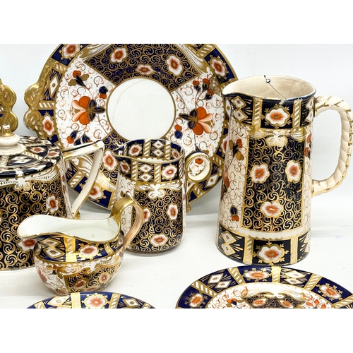 239 - A 19th Century Imari porcelain tea service. Red Crown Mark. Davenport/Derby. 16 pieces.