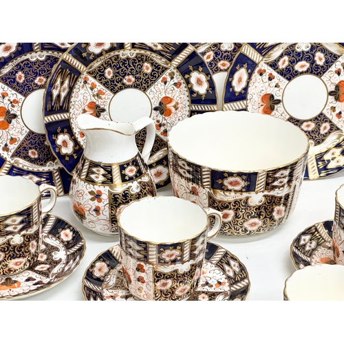 240 - A 32 piece 19th/Early 20th Century Imari pattern tea service. Red Crown and 2 Swords Mark.