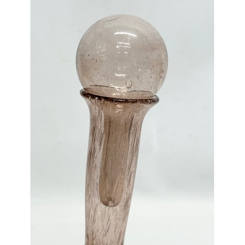 180 - A French controlled bubble glass carafe and stopper. 24x26cm.