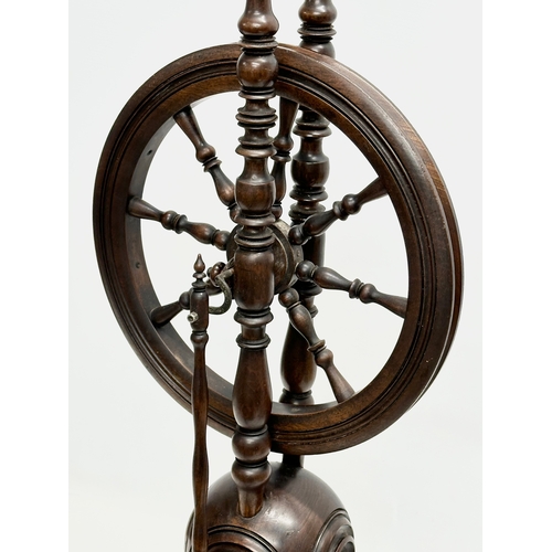 268 - An Early 20th Century spinning wheel. 92cm