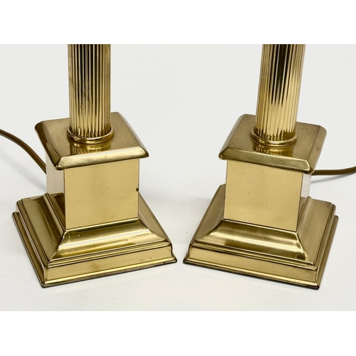 303 - A pair of brass table lamps with reeded columns. 42cm.