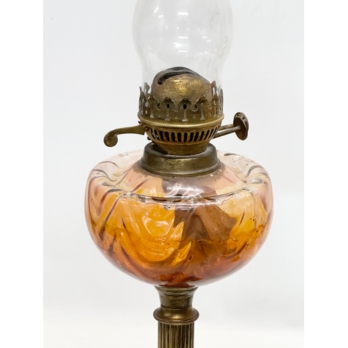 272 - A tall 19th Century Victorian double burner oil lamp. With reeded brass column and glass bowl. 67cm