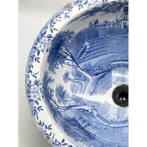 305 - A Victorian blue and white ceramic sink/plug basin. 37x19cm