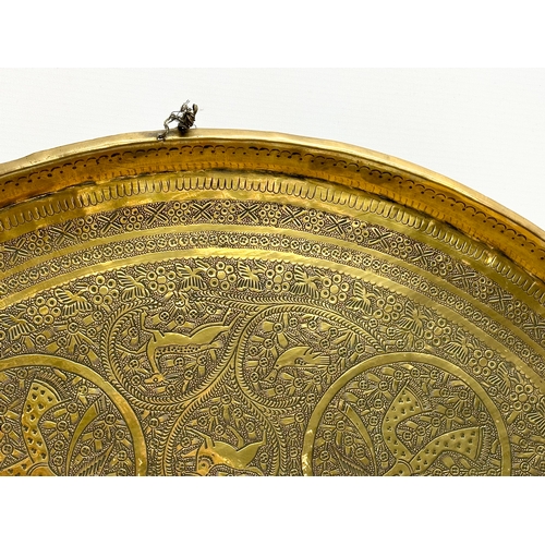 274 - A large 19th Century Indian brass tray/wall plaque. 61cm.