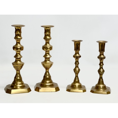 447 - 2 pairs of Late Victorian brass candlesticks. 25cm. 20cm.