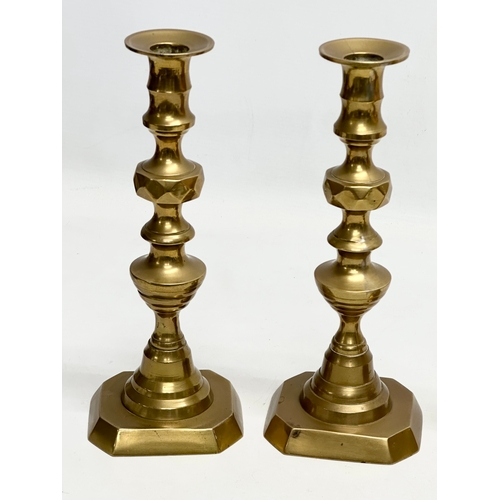 447 - 2 pairs of Late Victorian brass candlesticks. 25cm. 20cm.