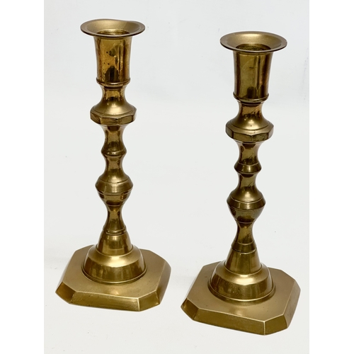 447 - 2 pairs of Late Victorian brass candlesticks. 25cm. 20cm.