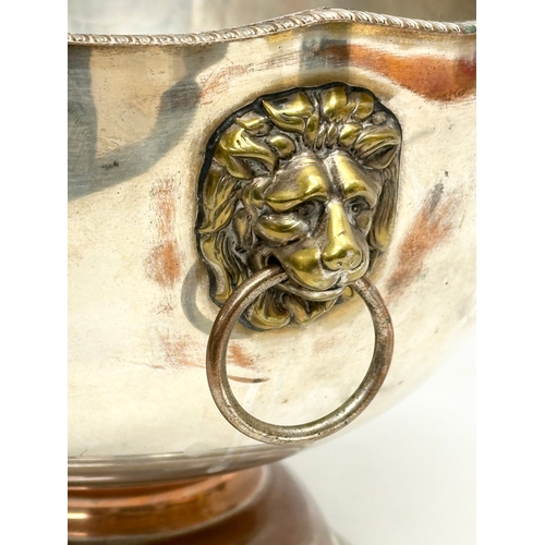 342 - A good quality Early 20th Century silver plated footed ice bucket, with brass lion mask ring handles... 