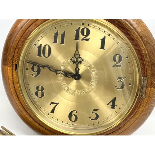 279 - A large Victorian style brass face wall clock/wag on the wall. With weights and pendulum. 41cm