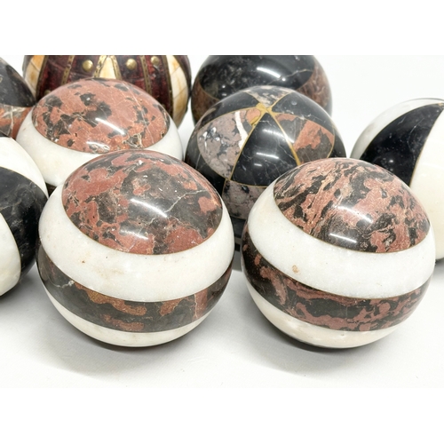 39 - A collection of Early 20th Century French marble balls. Including a larger leather and brass bound, ... 