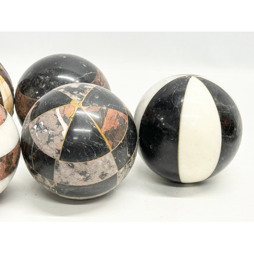 39 - A collection of Early 20th Century French marble balls. Including a larger leather and brass bound, ... 