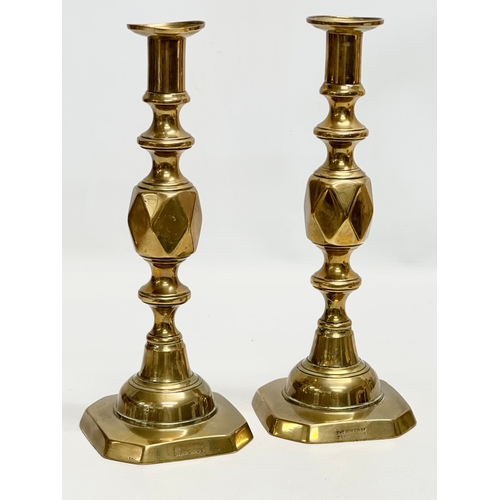 446 - A pair of Victorian brass candlesticks. The King and Queen of Diamonds. 29cm