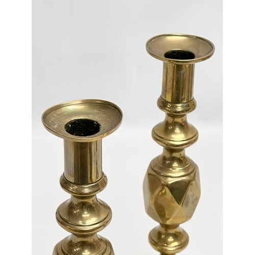 446 - A pair of Victorian brass candlesticks. The King and Queen of Diamonds. 29cm