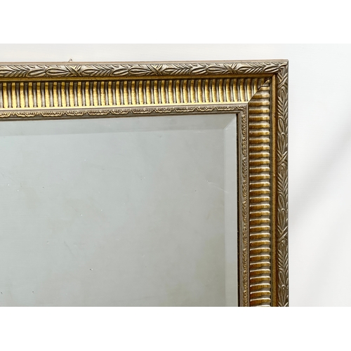 291 - A large gilt framed mirror with bevelled glass. 106x75cm