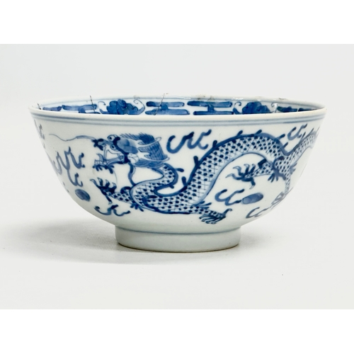 348 - A 19th Century Chinese bowl. Emperor Kangxi mark (1662-1722) With three dragons and flaming pearl. 4... 