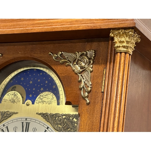 379 - A large Georgian style wall clock with brass moon dial face. 3 weights and pendulum. 44x26x126cm.