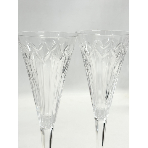 341E - A set of 4 Stuart Crystal champagne glasses. 23.5cm.