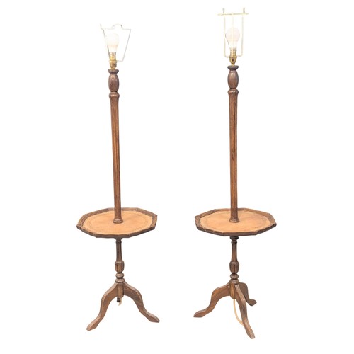 1095 - A pair of leather top side tables / standard lamps. 133cm. 6