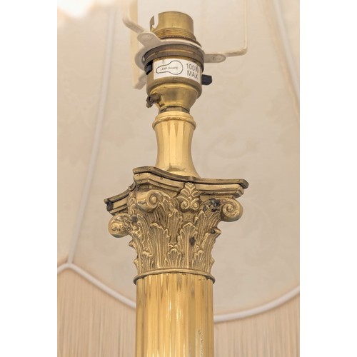 1096 - A brass standard lamp with Corinthian style column. 167cm. 6