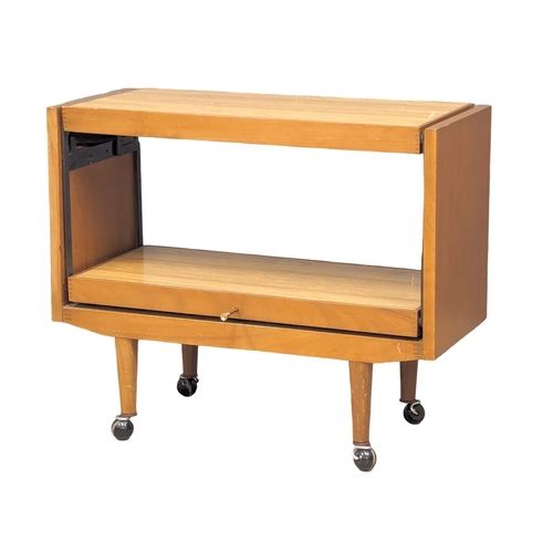 1101 - A Mid Century metamorphic trolley. 89x38.5x74.5cm.(8)