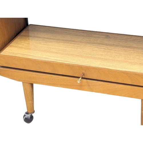 1101 - A Mid Century metamorphic trolley. 89x38.5x74.5cm.(8)