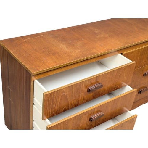 1102 - A Mid Century teak chest of drawers. 138x41.5x69.5cm.(10)