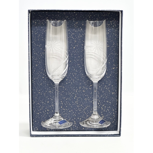 411 - A pair of Waterford Marquis “Millennium” champagne flutes with box. 23cm